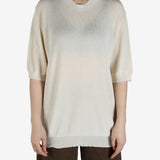 White top worn by a person, showing the top's fit