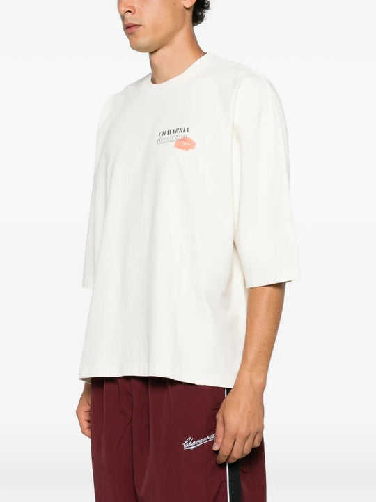 White t-shirt worn by a person, showing the t-shirt fit