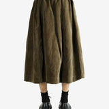 Green skirt worn by a person, showing the skirt's fit