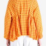 Orange shirt worn by a person, showing the shirt fit