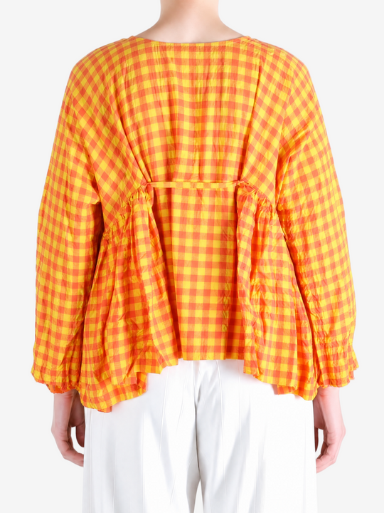 Orange shirt worn by a person, showing the shirt fit