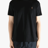 Black t-shirts worn by a person, showing the t-shirts fit