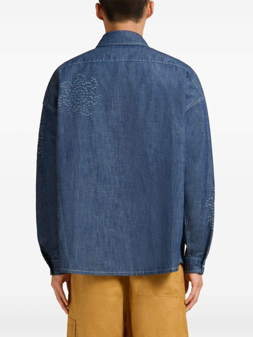 Blue shirts worn by a person, showing the shirts fit