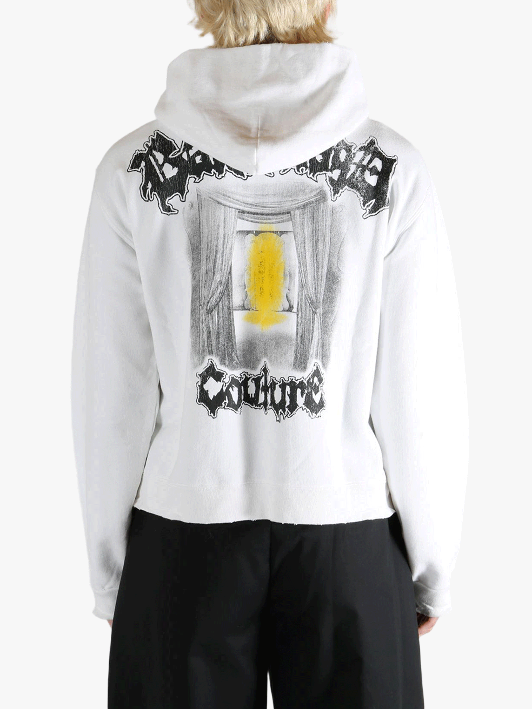 White hoodie worn by a person, showing the shirt's fit