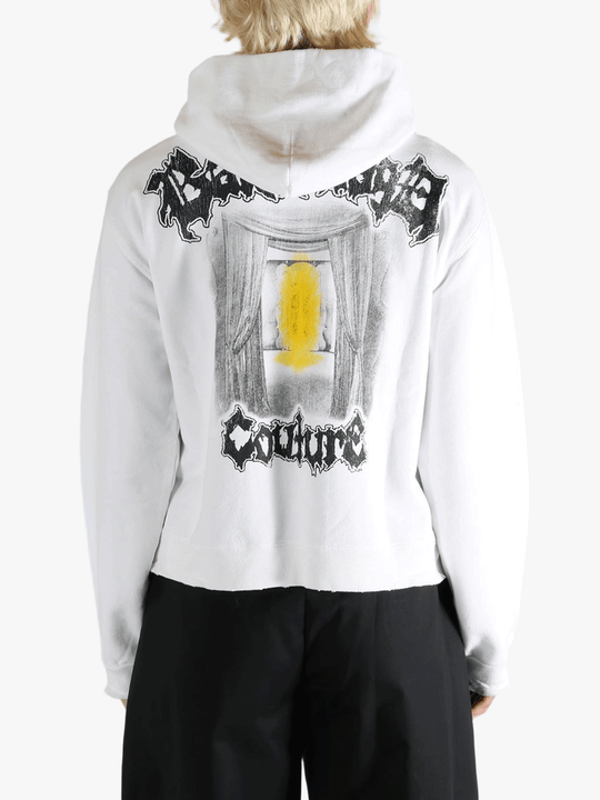 White hoodie worn by a person, showing the shirt's fit