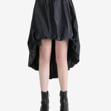 Grey skirts worn by a person, showing the skirts fit