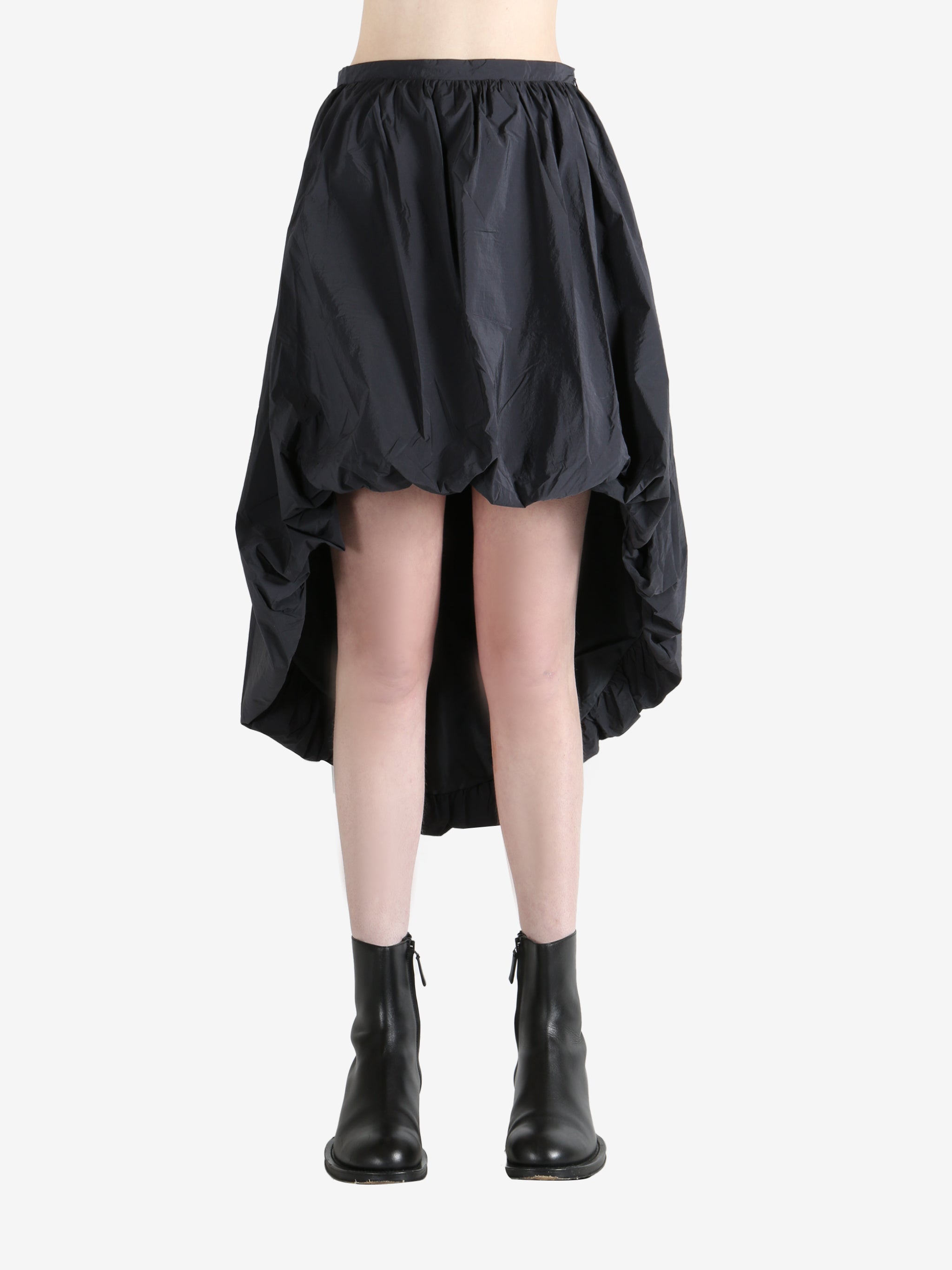 Grey skirts worn by a person, showing the skirts fit