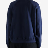 Navy knitwear worn by a person, showing the knitwear fit
