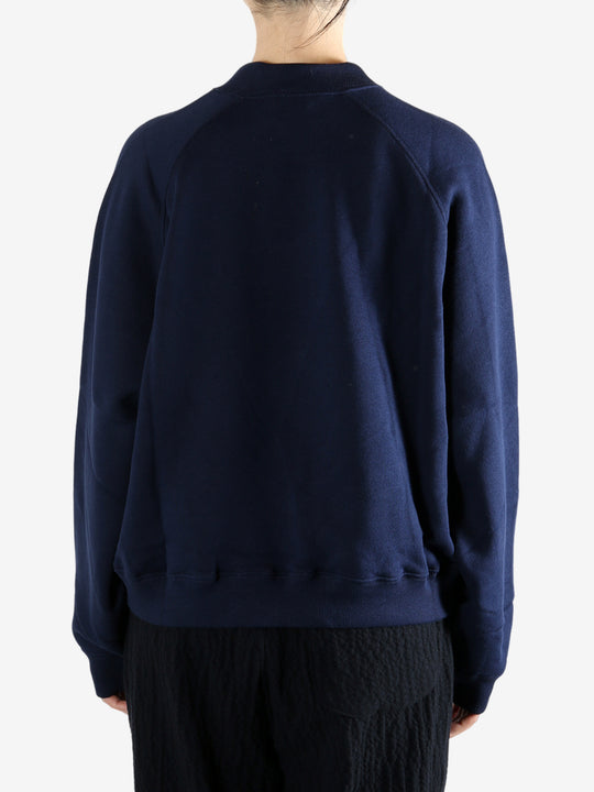 Navy knitwear worn by a person, showing the knitwear fit