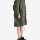 Green coat worn by a person, showing the coat fit