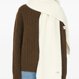 White scarf worn by a person, showing the scarf's fit