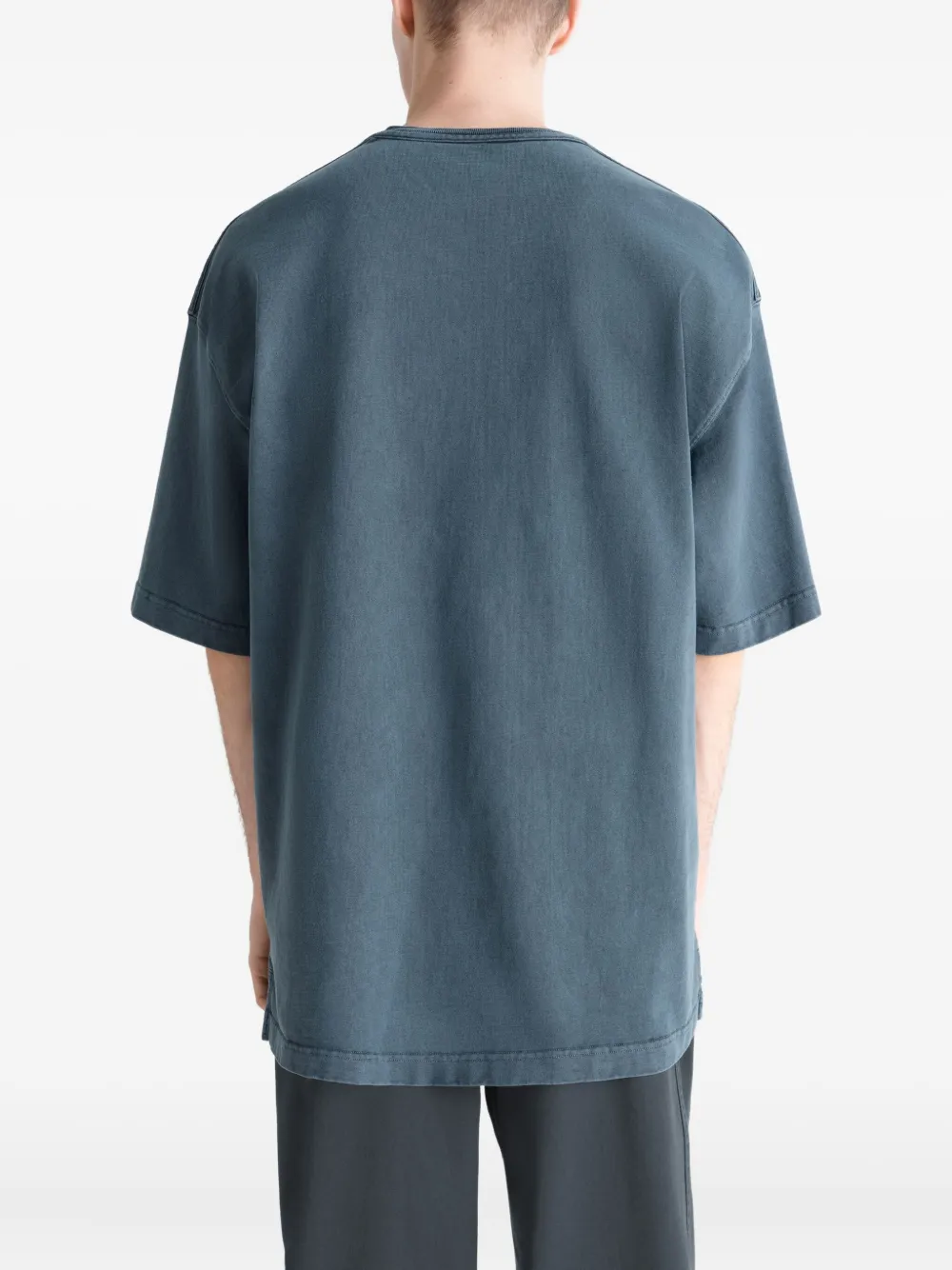 Blue t-shirt worn by a person, showing the t-shirt's fit