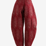 Red pants worn by a person, showing the pants's fit