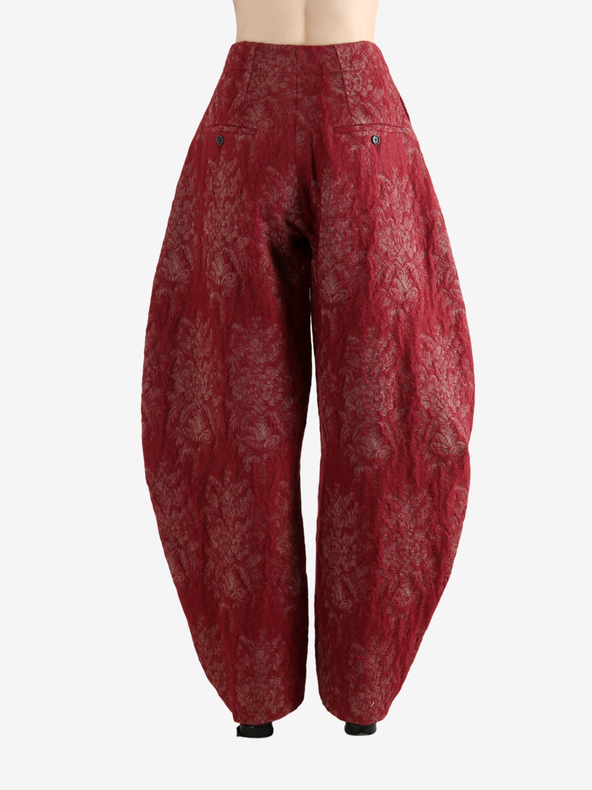 Red pants worn by a person, showing the pants's fit