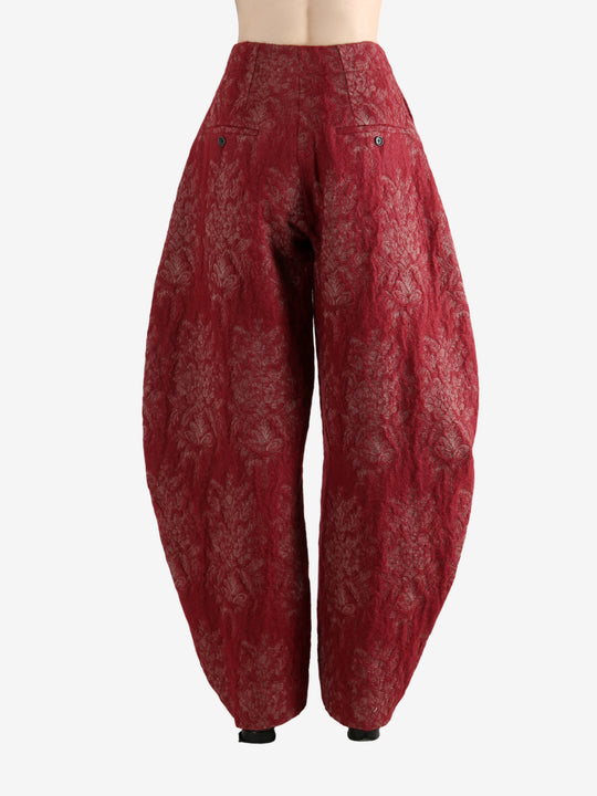 Red pants worn by a person, showing the pants's fit