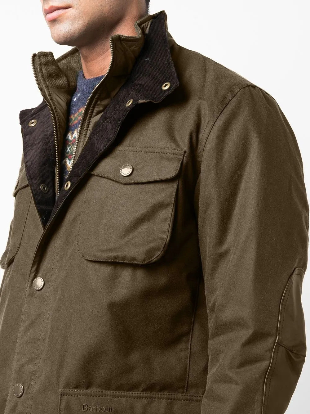 Green jacket worn by a person, showing the jacket fit