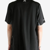 Black shirt worn by a person, showing the shirt's fit