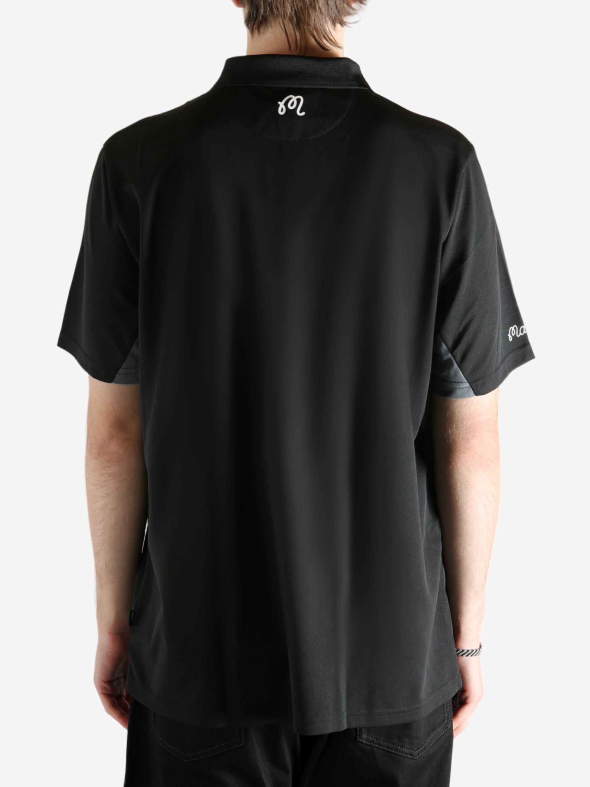 Black shirt worn by a person, showing the shirt's fit