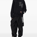 black pants worn by a person, showing the pants fit