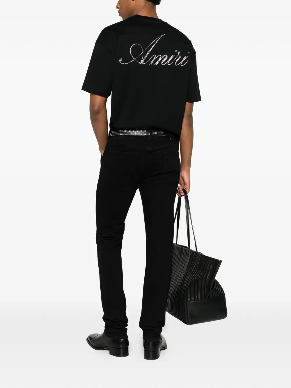  black t-shirt warn a person,showing the t-shirts fit