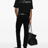  black t-shirt warn a person,showing the t-shirts fit