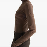 Brown top worn by a person, showing the top fit