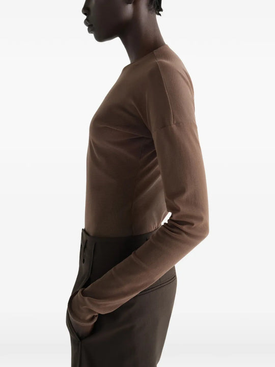 Brown top worn by a person, showing the top fit