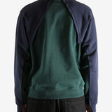 Green sweatshirt worn by a person, showing the sweatshirt's fit