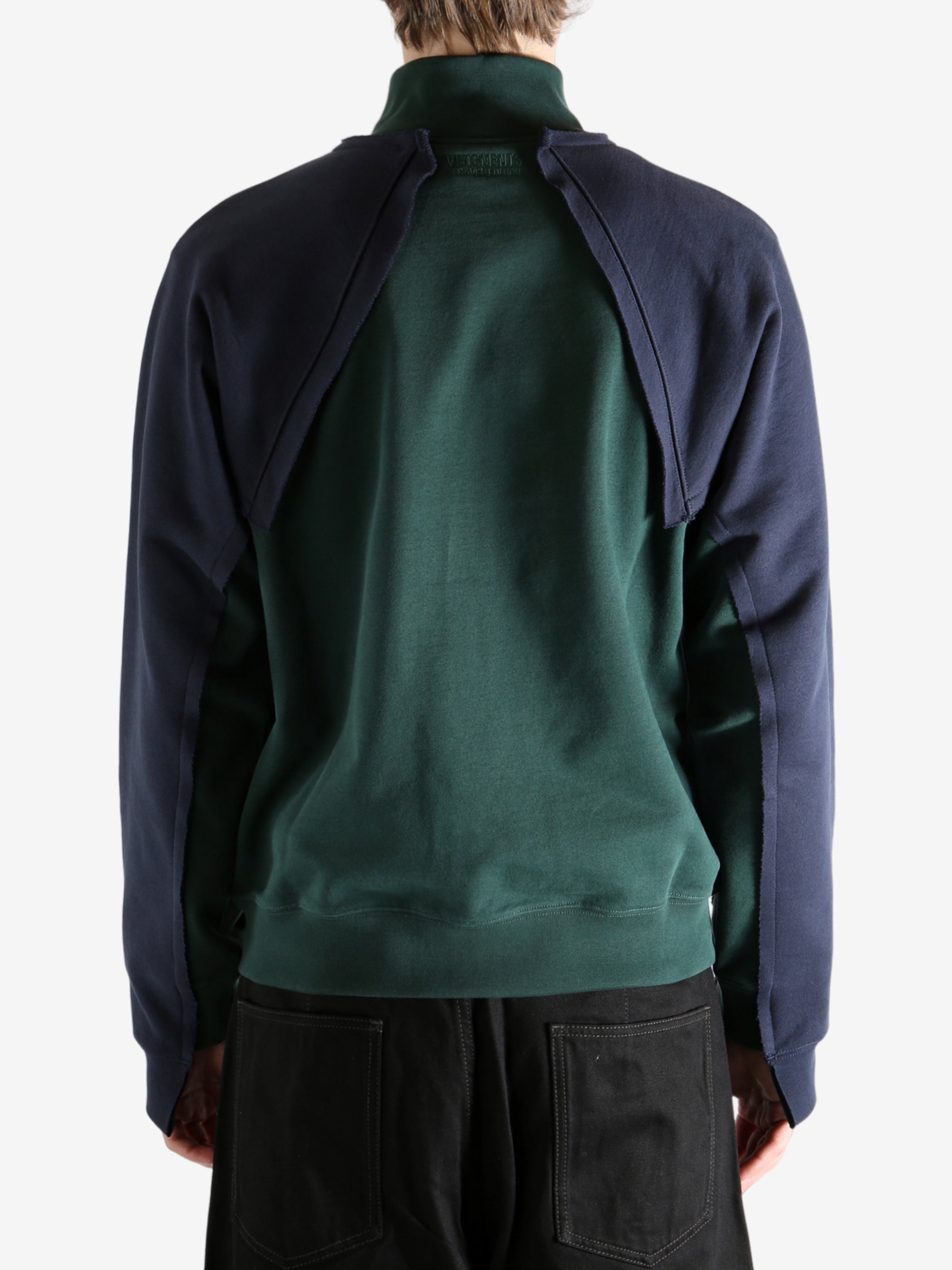 Green sweatshirt worn by a person, showing the sweatshirt's fit
