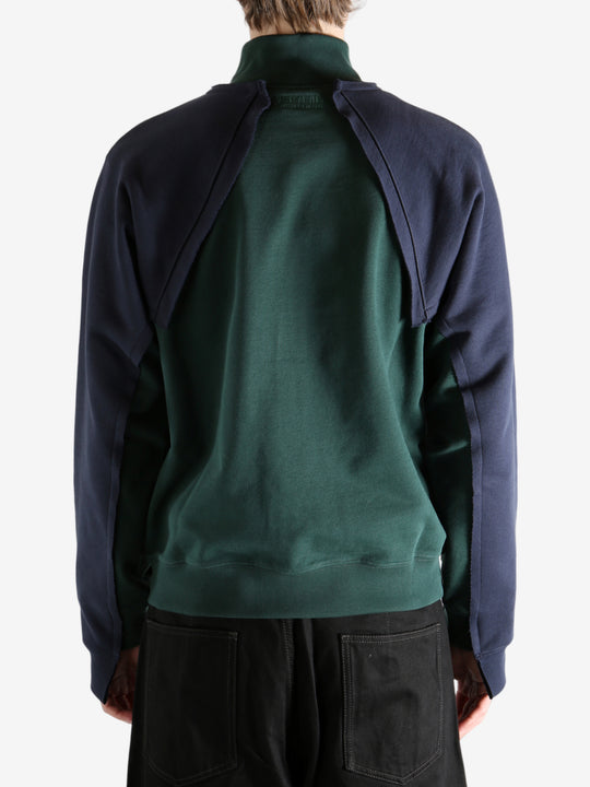 Green sweatshirt worn by a person, showing the sweatshirt's fit