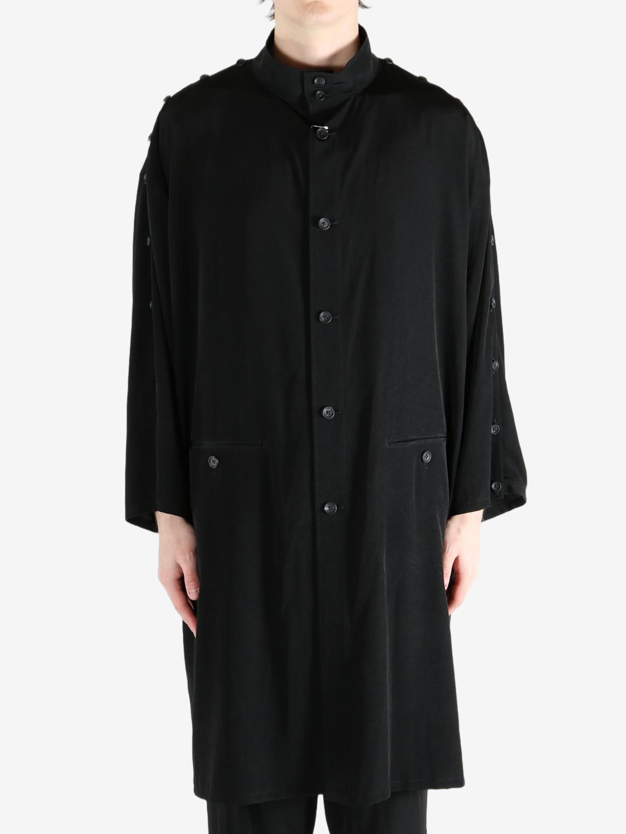 black jackets-coats worn by a person, showing the jackets-coats fit