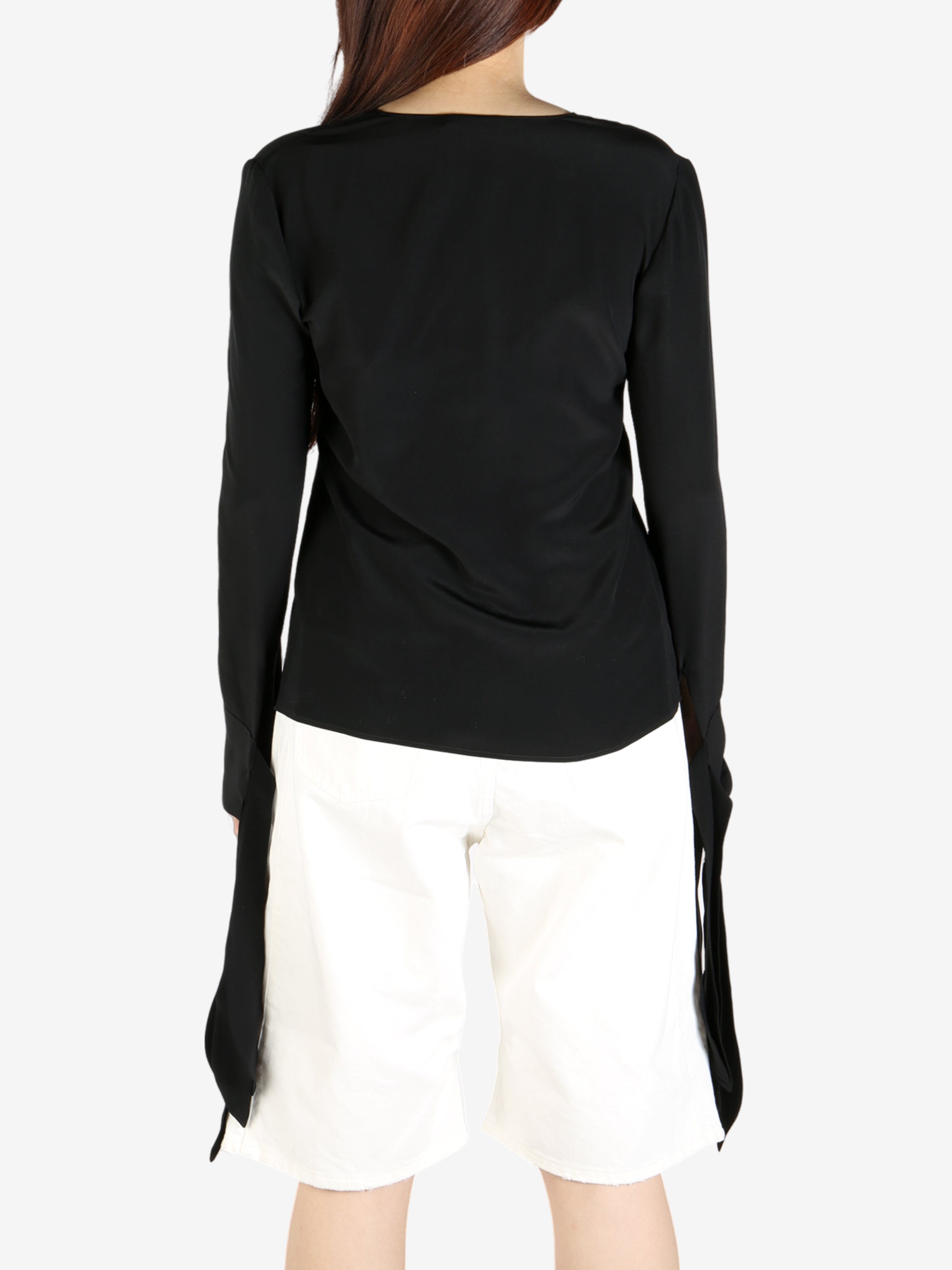 Black top worn by a person, showing the top's fit