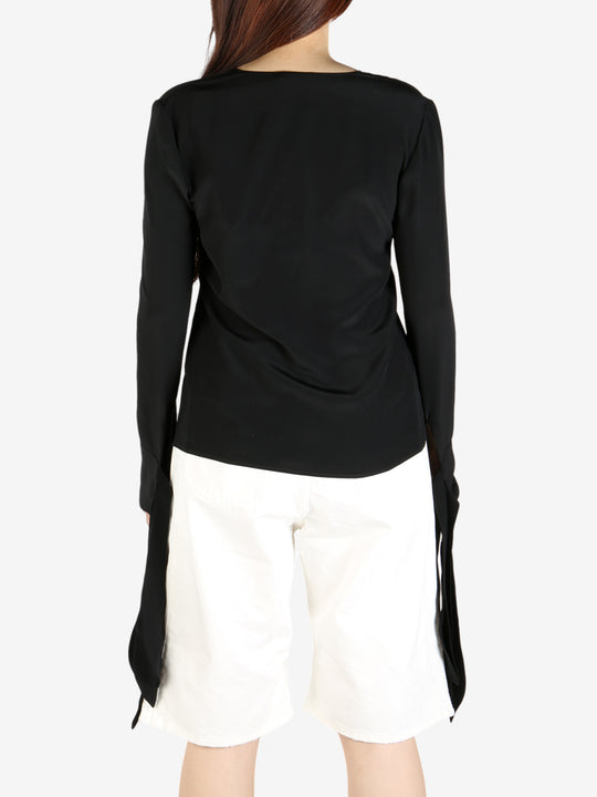 Black top worn by a person, showing the top's fit