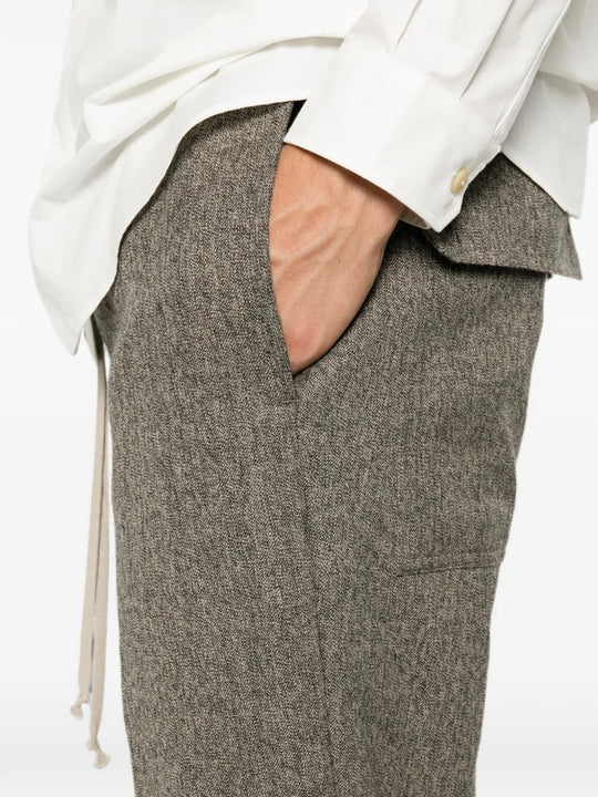Grey pants worn by a person, showing the pants fit