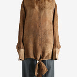 Brown top worn by a person, showing the top's fit