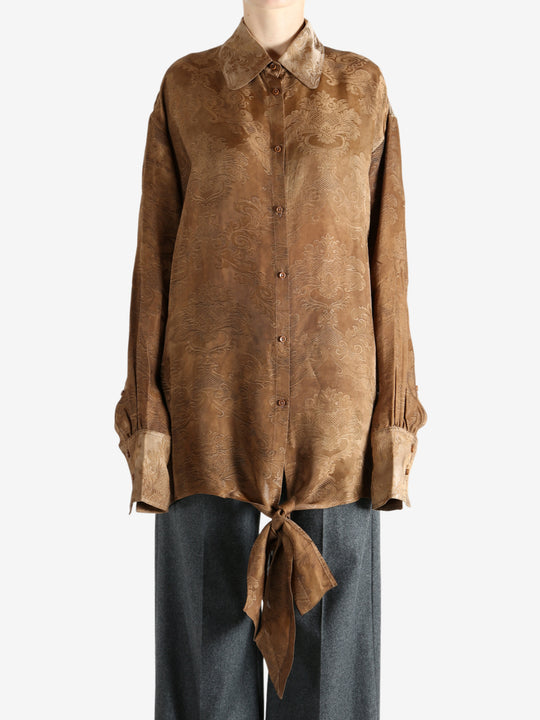 Brown top worn by a person, showing the top's fit