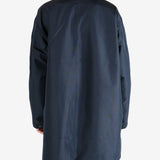 Navy jackets worn by a person, showing the jacket’s fit