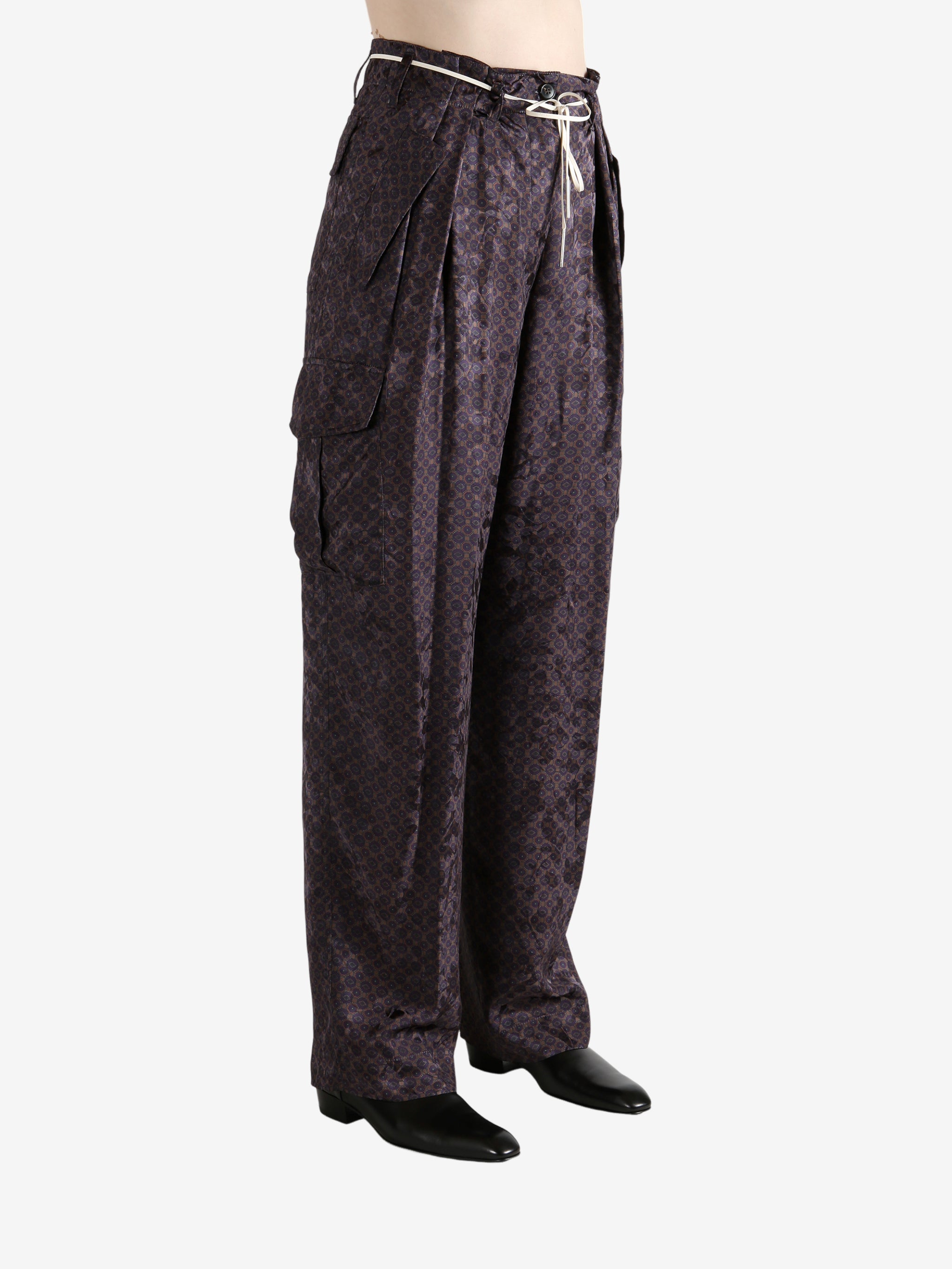 Brown pant worn by a person, showing the pant's fit