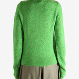 Green knitwear worn by a person, showing the knitwear fit