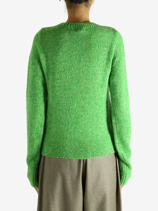 Green knitwear worn by a person, showing the knitwear fit