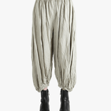 Grey pants worn by a person, showing the pants fit