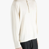 white sweater worn by a person, showing the sweater's fit