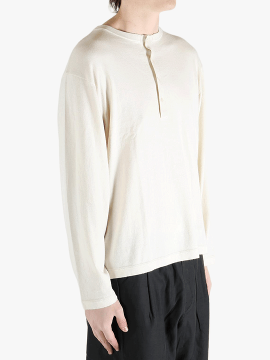 white sweater worn by a person, showing the sweater's fit