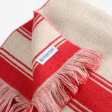 Close up of red scarves, showing texture of the fabric