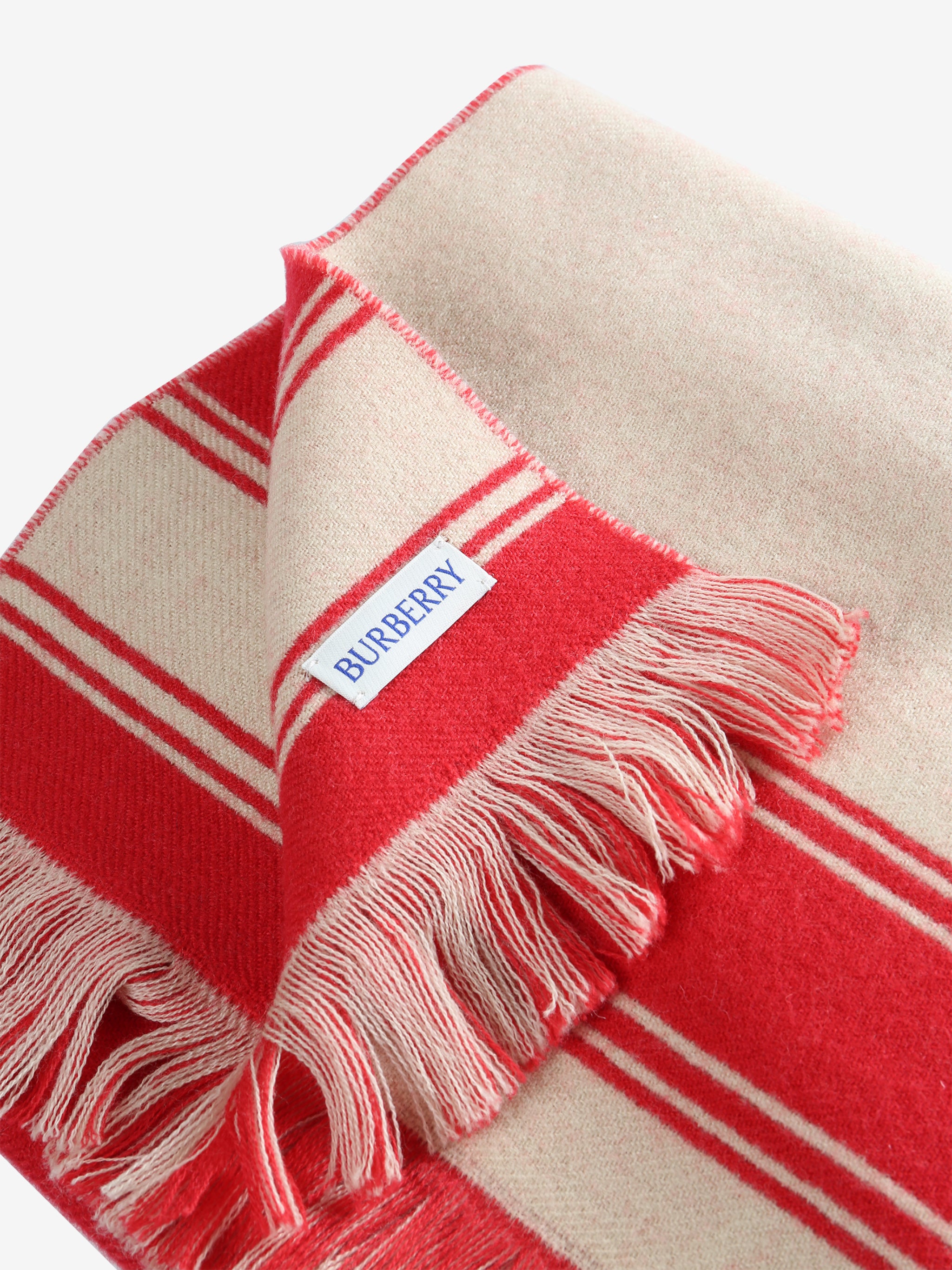 Close up of red scarves, showing texture of the fabric