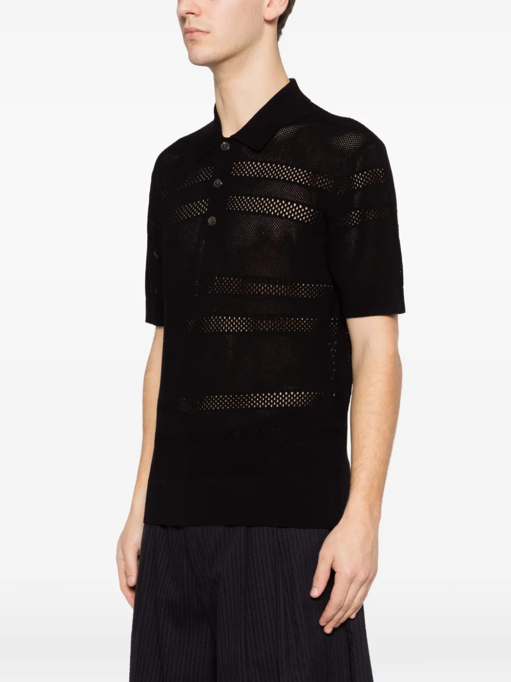 black knitwear worn by a person, showing the knitwear fit