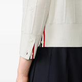 Close up of the white knitwear, showing texture of the wool fabric