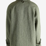 Green jacket worn by a person, showing the jacket fit