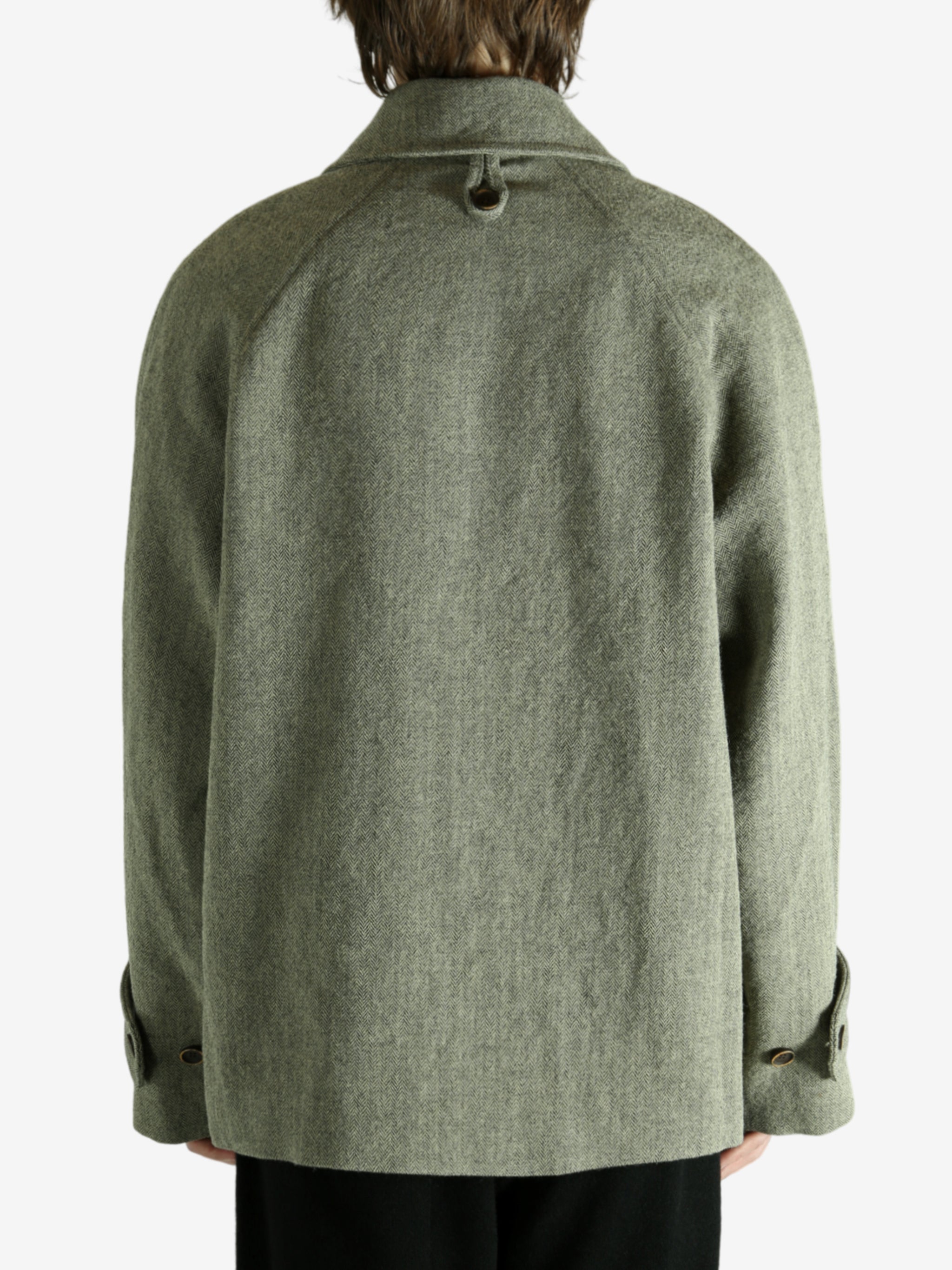 Green jacket worn by a person, showing the jacket fit