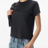 Black top worn by a person, showing the top fit